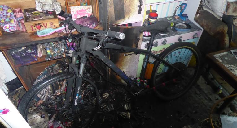 An e-bike damaged by a lithium-ion battery fire