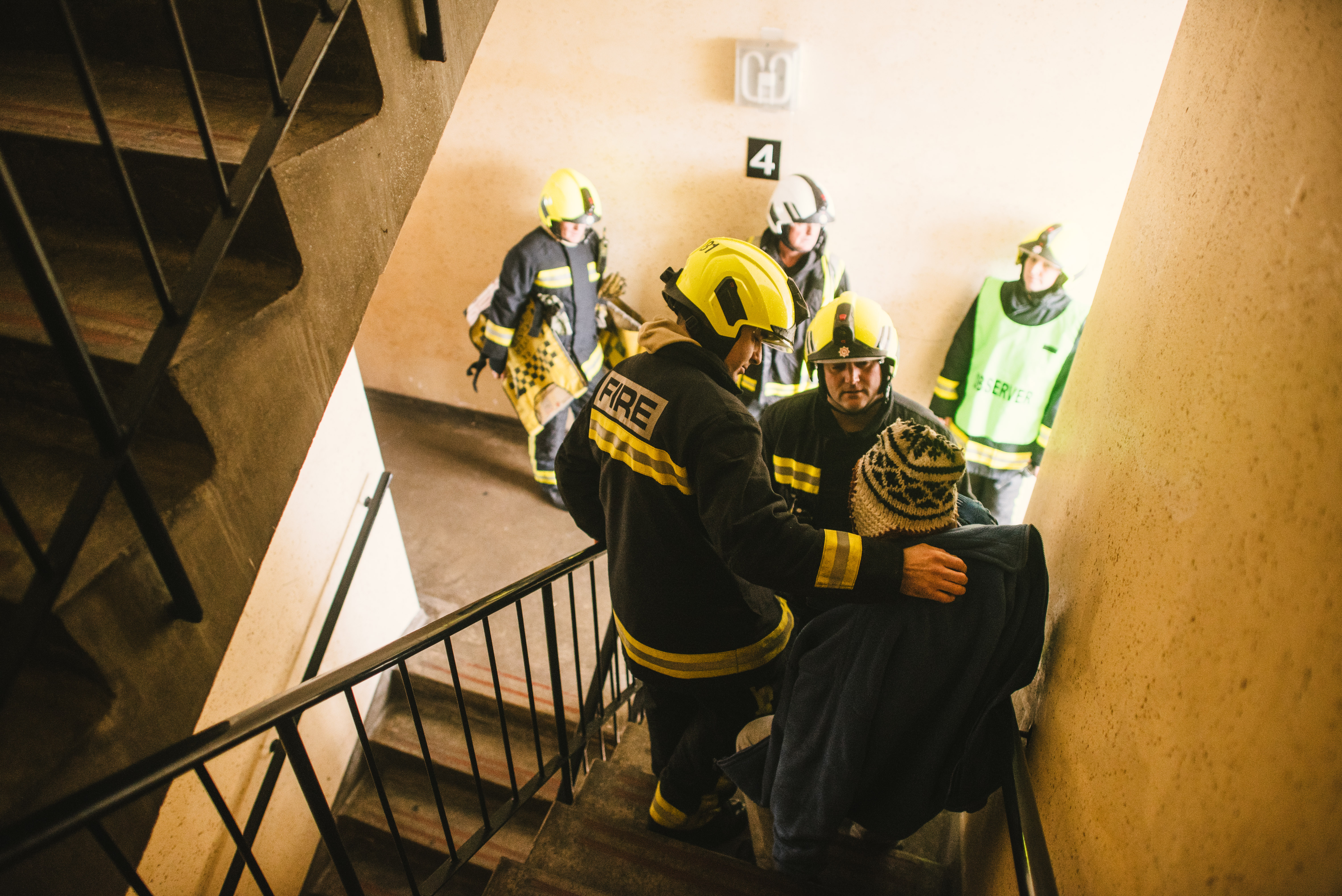 Firefighter helping man out of building