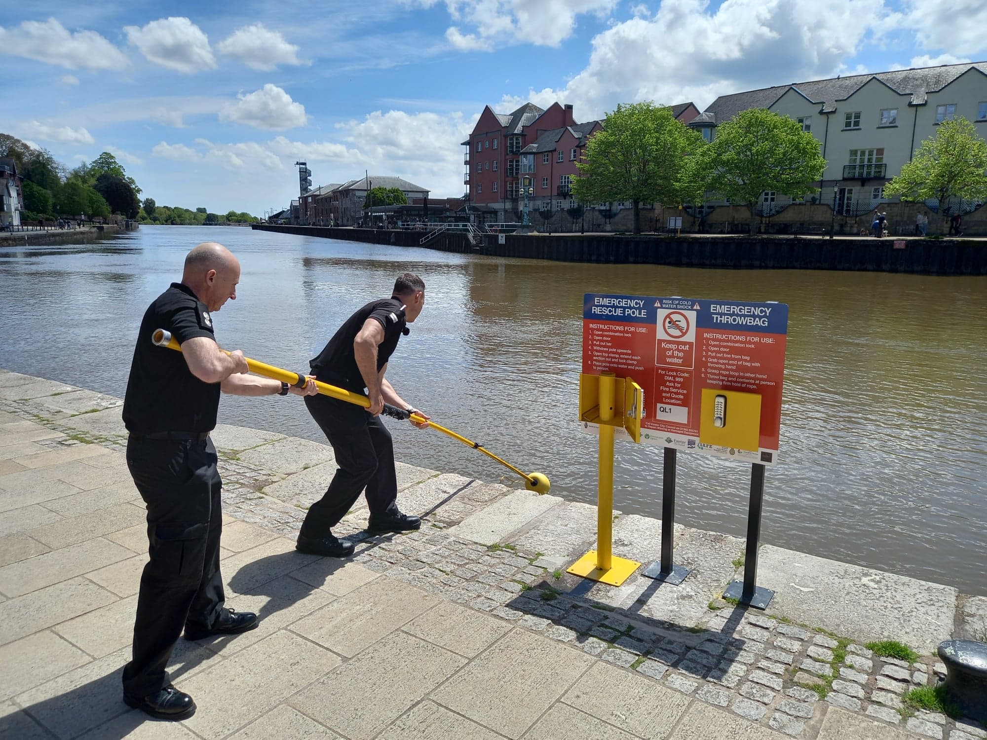 Firefighters using a reach pole