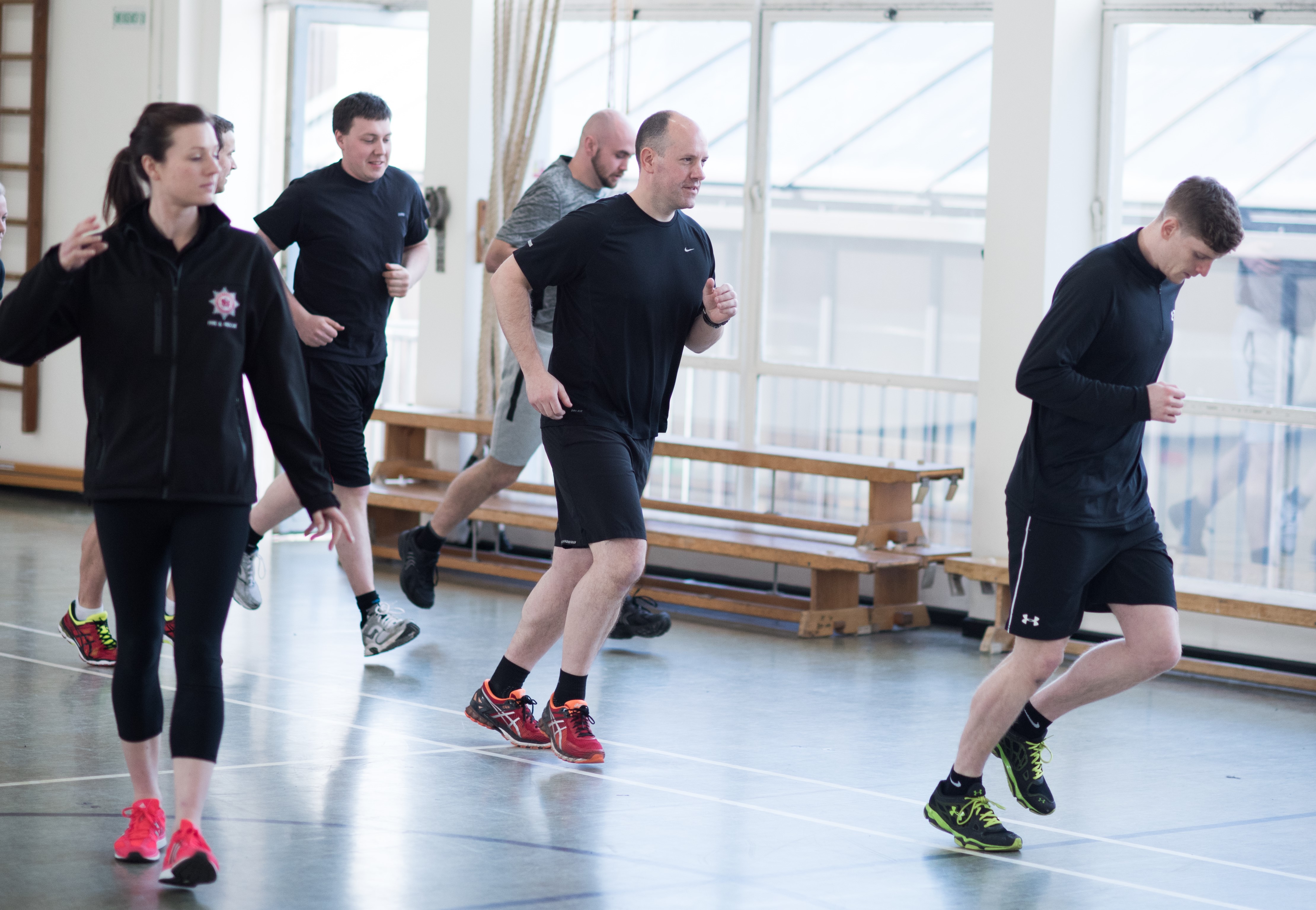 People exercising to get ready for the bleep test.