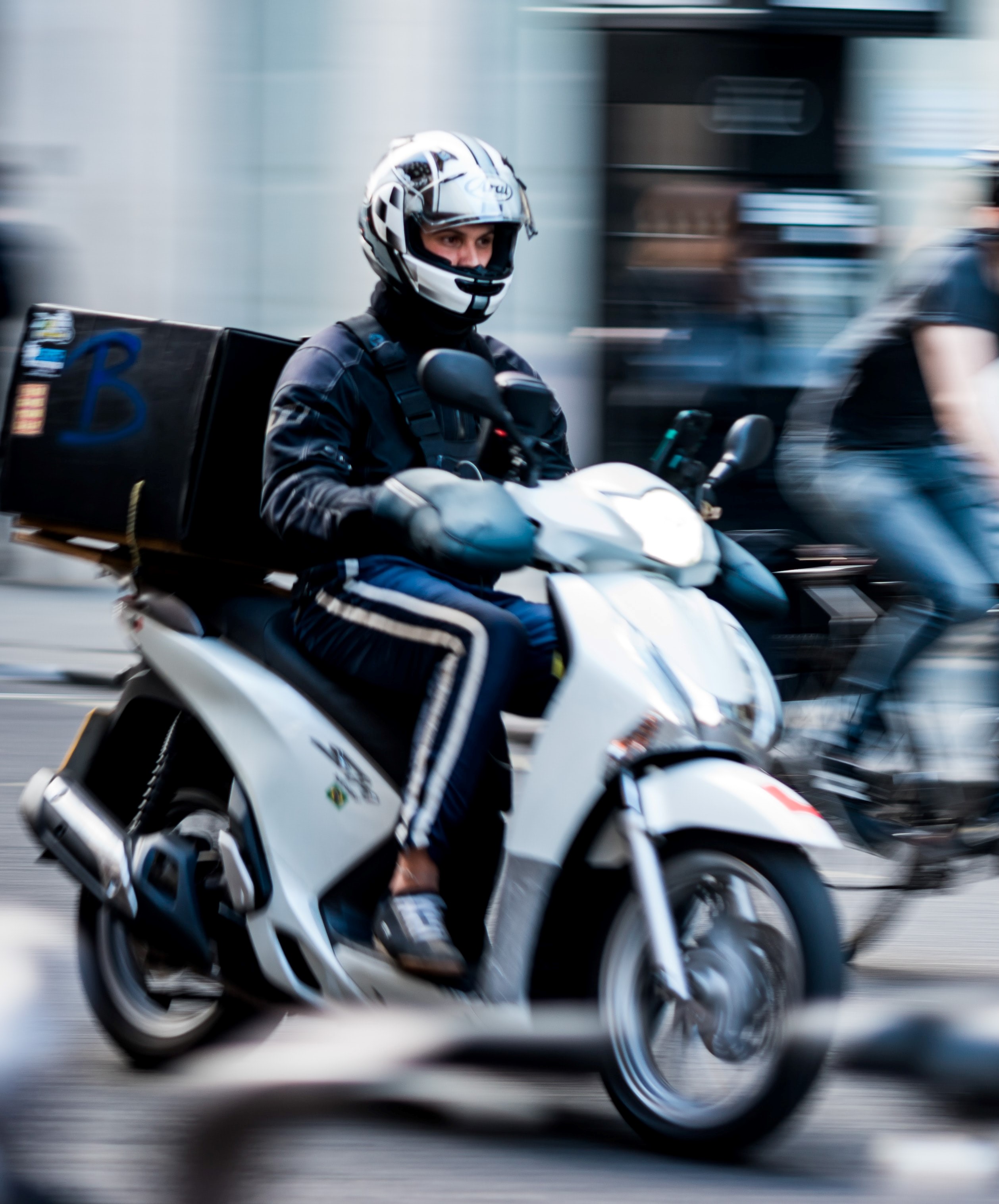 Motorcyclist riding on a busy street.