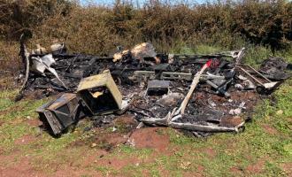 What once was a caravan in a field, completely burnt to the ground and destroyed.