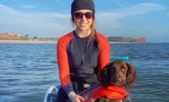 Elsie on her paddleboard with her dog