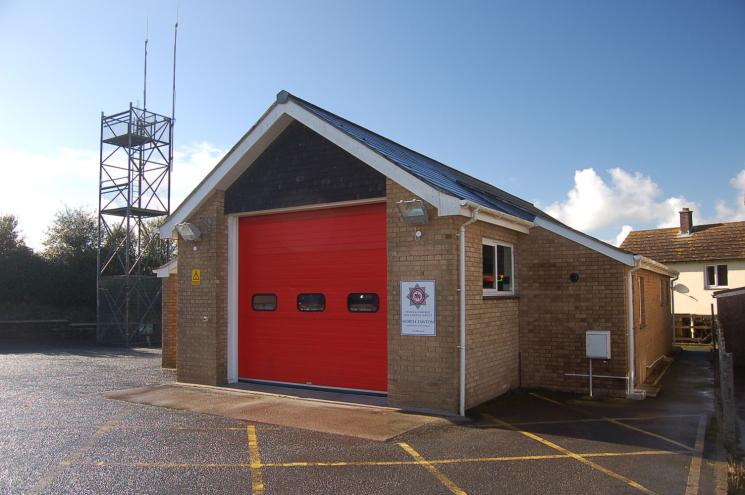 North Tawton Fire Station's brick building, with one red garage.