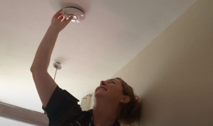 One of our home safety technicians installing a FireAngel smoke alarm in someone's home.
