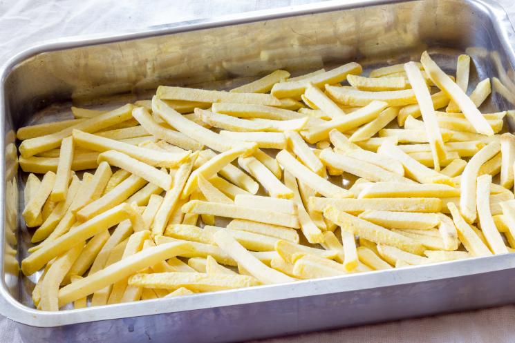 A tray of thin oven chips ready to cook.