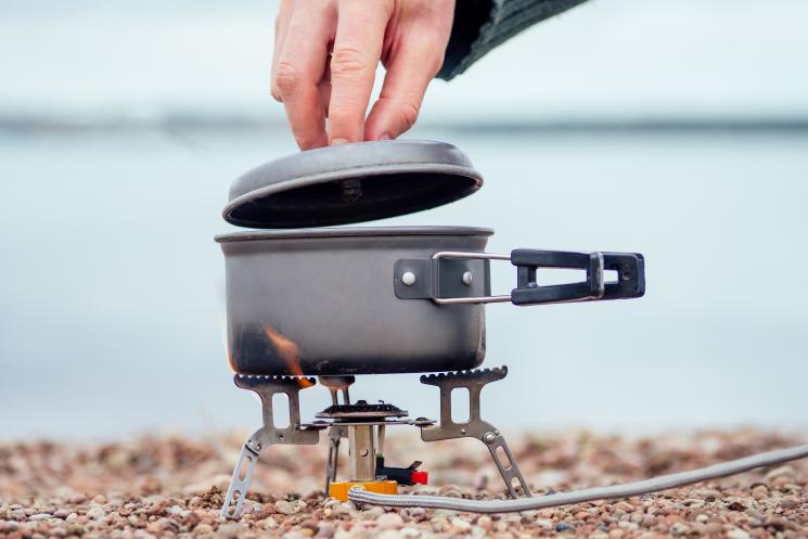 portable gas stove on pebble beach