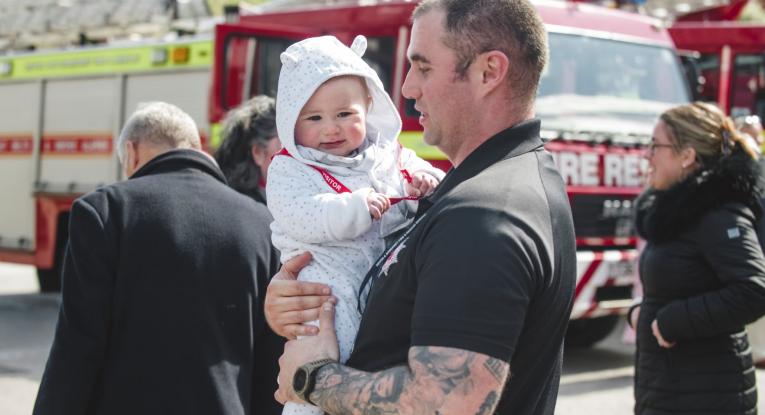 Firefighter holding a baby
