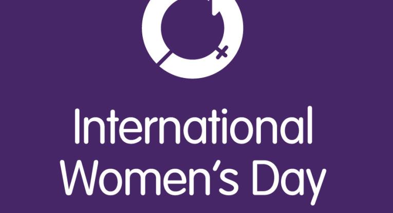 The text 'international women's day' on a purple background 
